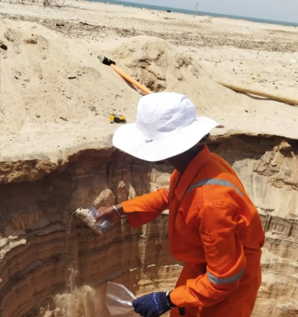 Examining a sand section in the field